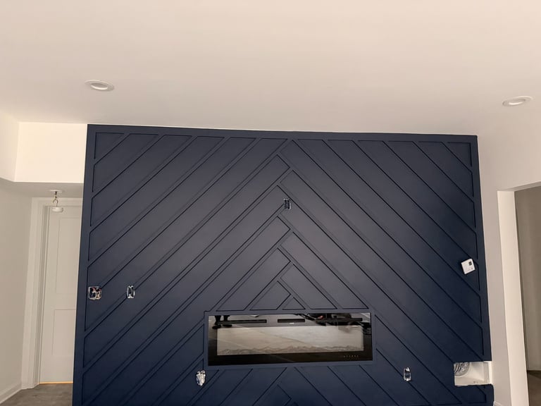 Interior wall with diagonal striped navy blue shiplap paneling and recessed horizontal shelf opening in center